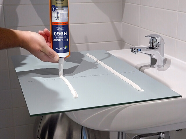 Adhesive being applied to the back of a mirror