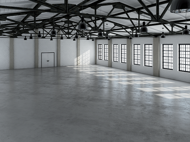 Empty hall with a concrete floor and big bay windows