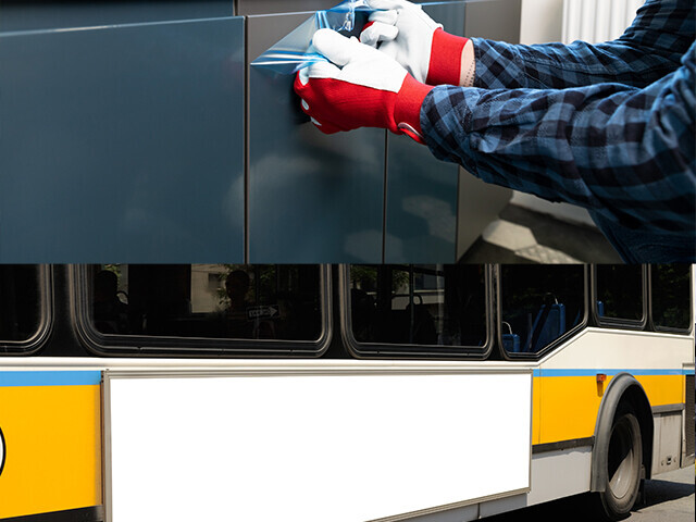 protective tinted film being removed from the side of a bus