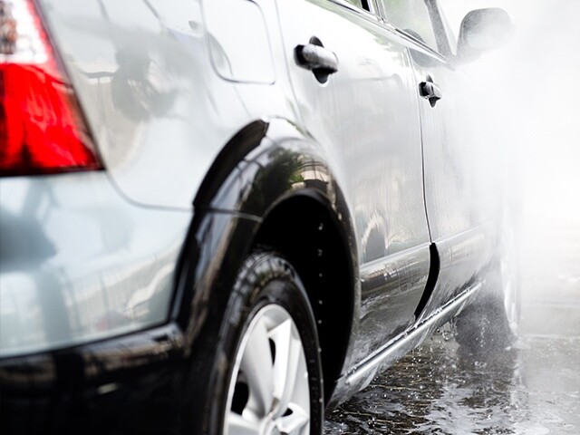 car sprayed with water to wash