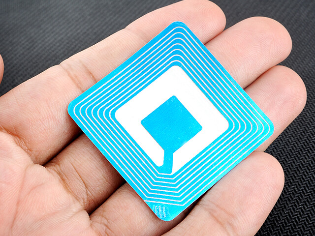 person holding an RFID card in the palm of their hand