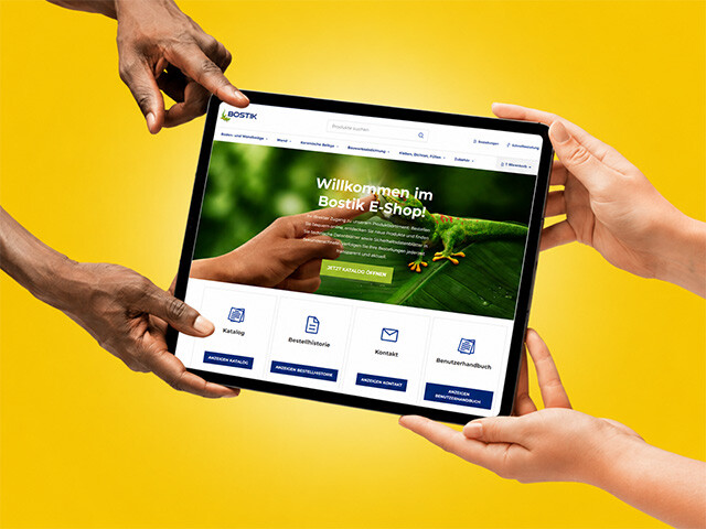 bostik e shop two pairs of hands holding a tablet featuring the bsotik e-shop