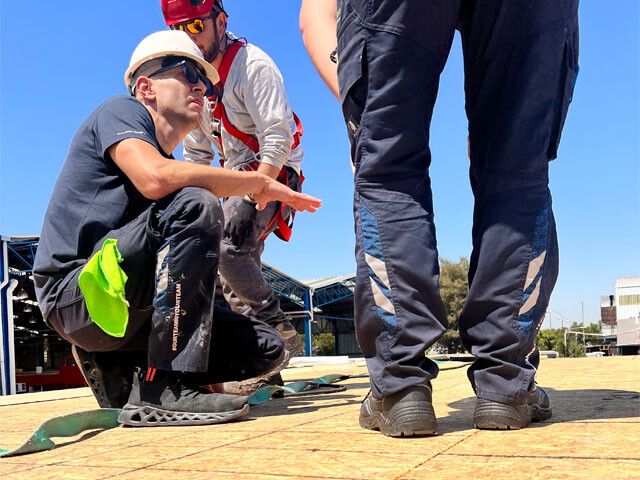Guy with a hardhat on a roof