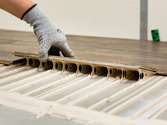 A wood floor being layed by a flooring specialst using Bostik adhesives for wooden floors
