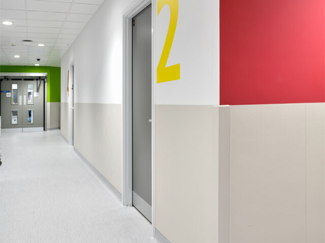 Hospital corridor hall with protective wall panels in place