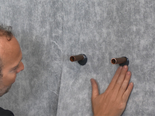 Guy applying a waterproofing system to a wall