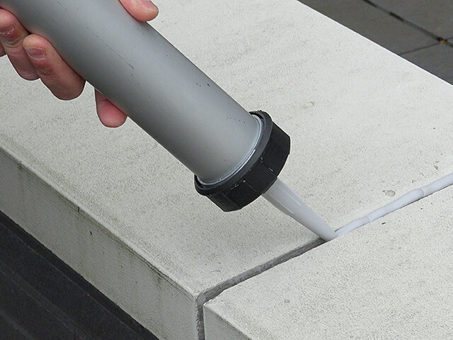 PU sealant application on concrete block