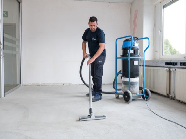 Vacuuming floor before flooring installation