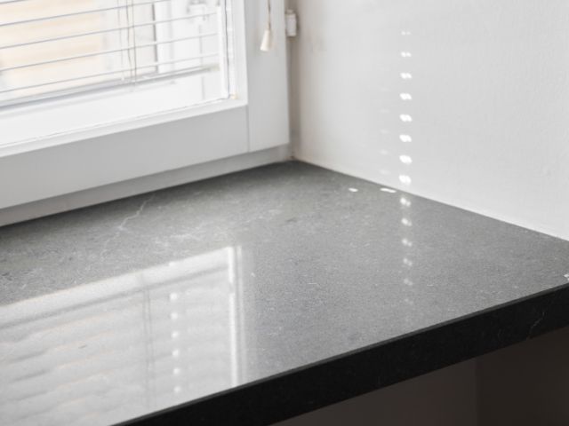 Close-up of a stone countertop joint near a window, sealed for a smooth and durable finish with Bostik adhesive.