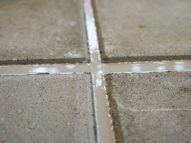 Close-up of a concrete pavement joint filled with Bostik chemical-resistant sealant, showing a smooth and durable sealed finish.