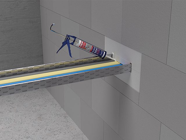 Technical illustration showing Bostik firestopping sealant applied around a service penetration through a wall, creating a fire-resistant barrier to help prevent the spread of fire and smoke.