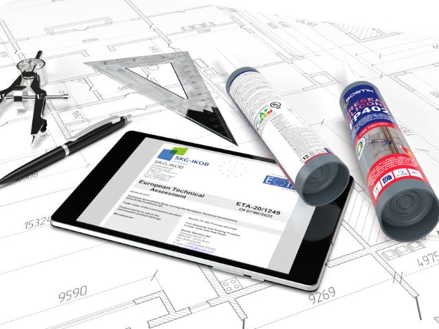 Technical documentation and Bostik passive fire protection products displayed on architectural drawings, highlighting certified firestopping systems for construction projects.