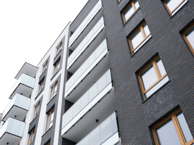 Modern residential building facade showing sealed joints and window connections using construction sealants.