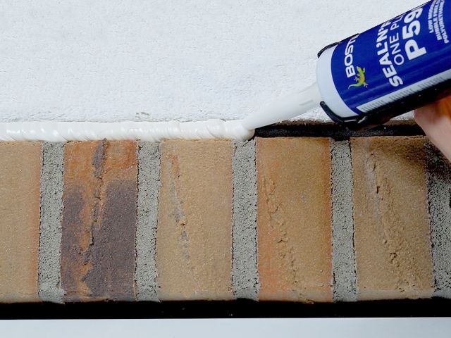Bostik P390 sealant applied along a brick wall joint to create a flexible seal between masonry and plaster.