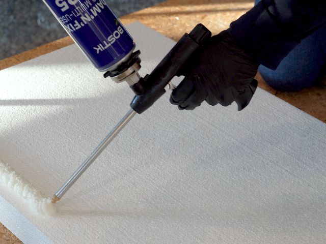Bostik Foam'N'Fill Turbo Multi-Use P925 expanding foam being applied to the edge of an insulation board, helping to seal gaps and enhance acoustic and thermal performance.