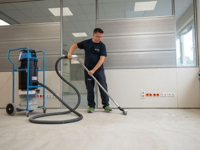 Vacuuming a repaired concrete subfloor
