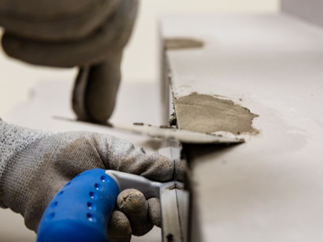 Trimming excess repair mortar from a concrete edge