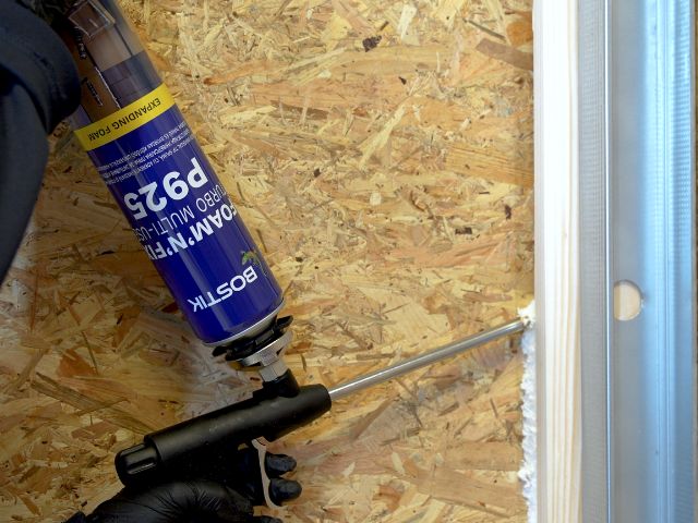 Bostik Foam'N'Fill Turbo Multi-Use P925 expanding foam being applied around a structural wall junction, sealing perimeter gaps to improve sound insulation and thermal efficiency.