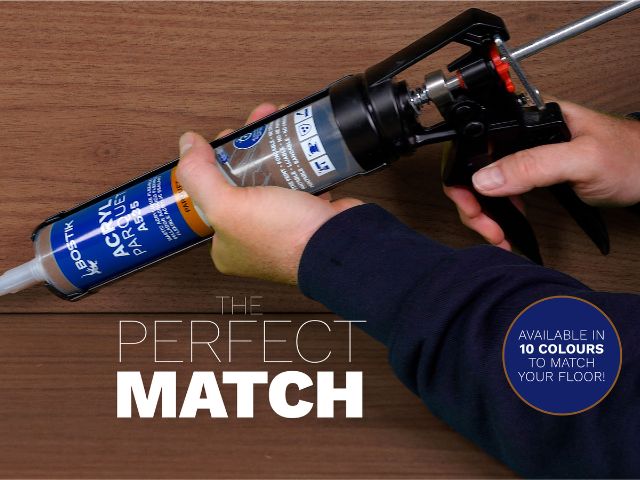 Bostik Acryl Parquet sealant cartridge being loaded into an applicator gun above a wooden floor, highlighting colour-matched sealing solutions for parquet and wood flooring.
