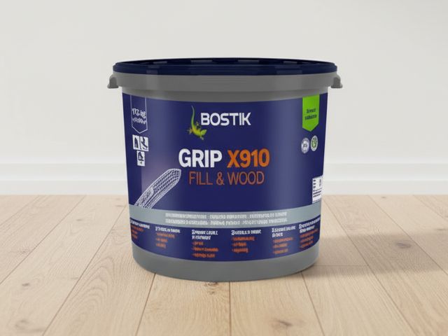 Bostik Grip X910 Fill & Wood floor adhesive bucket displayed on a wooden floor with product label clearly visible.