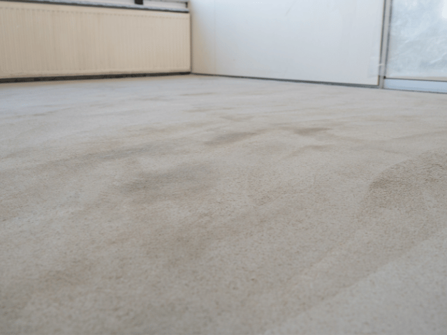 Prepared and level concrete subfloor after adhesive application, ready for Bostik flooring installation.