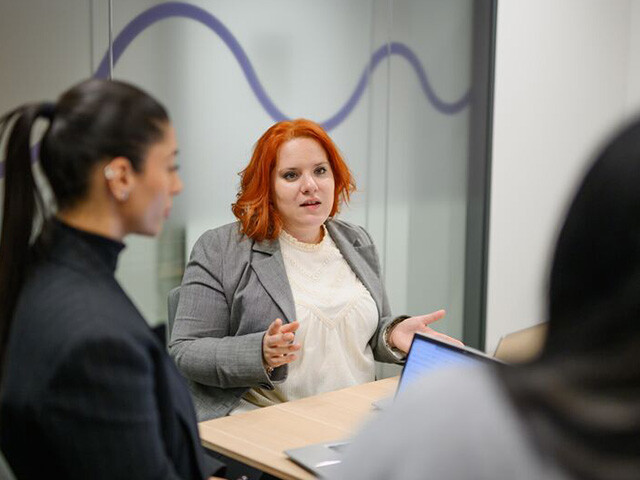 Cecilia in a business meeting with colleagues