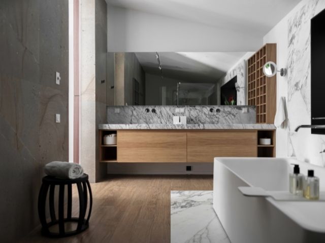 Modern bathroom interior featuring tiled walls, wood flooring, stone surfaces, and professional wall and floor installation finishes in a residential setting.