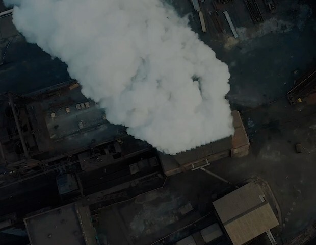 plums of smoke coming out from industrial smoke stacks