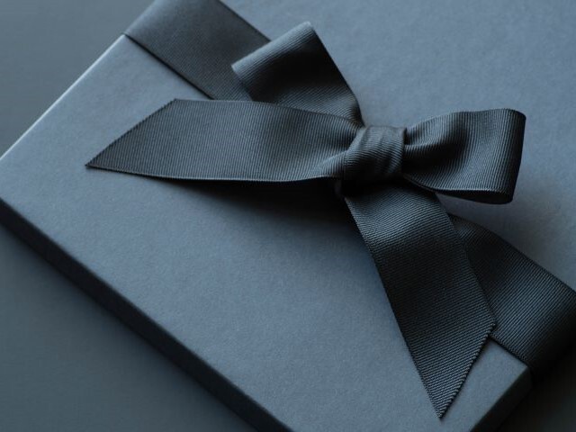 A luxury box wrapped with a color matching high quality black fabric that exudes elegance.