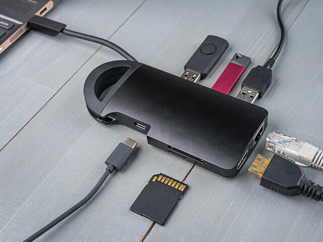 electronics dongle with USB, mini-USB, ethernet, HDMI ports and cables connecting to it.