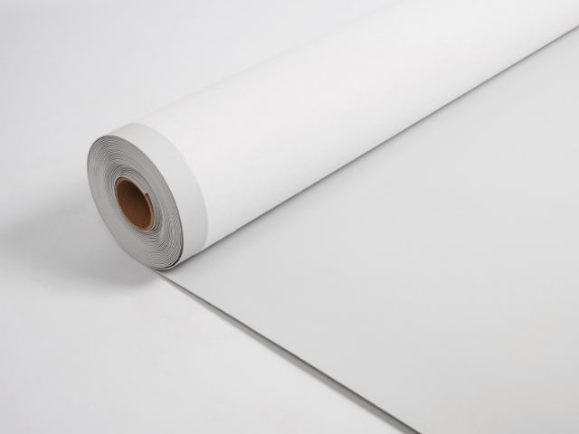 Roll of white roofing underlayment partially unrolled on a clean white surface.